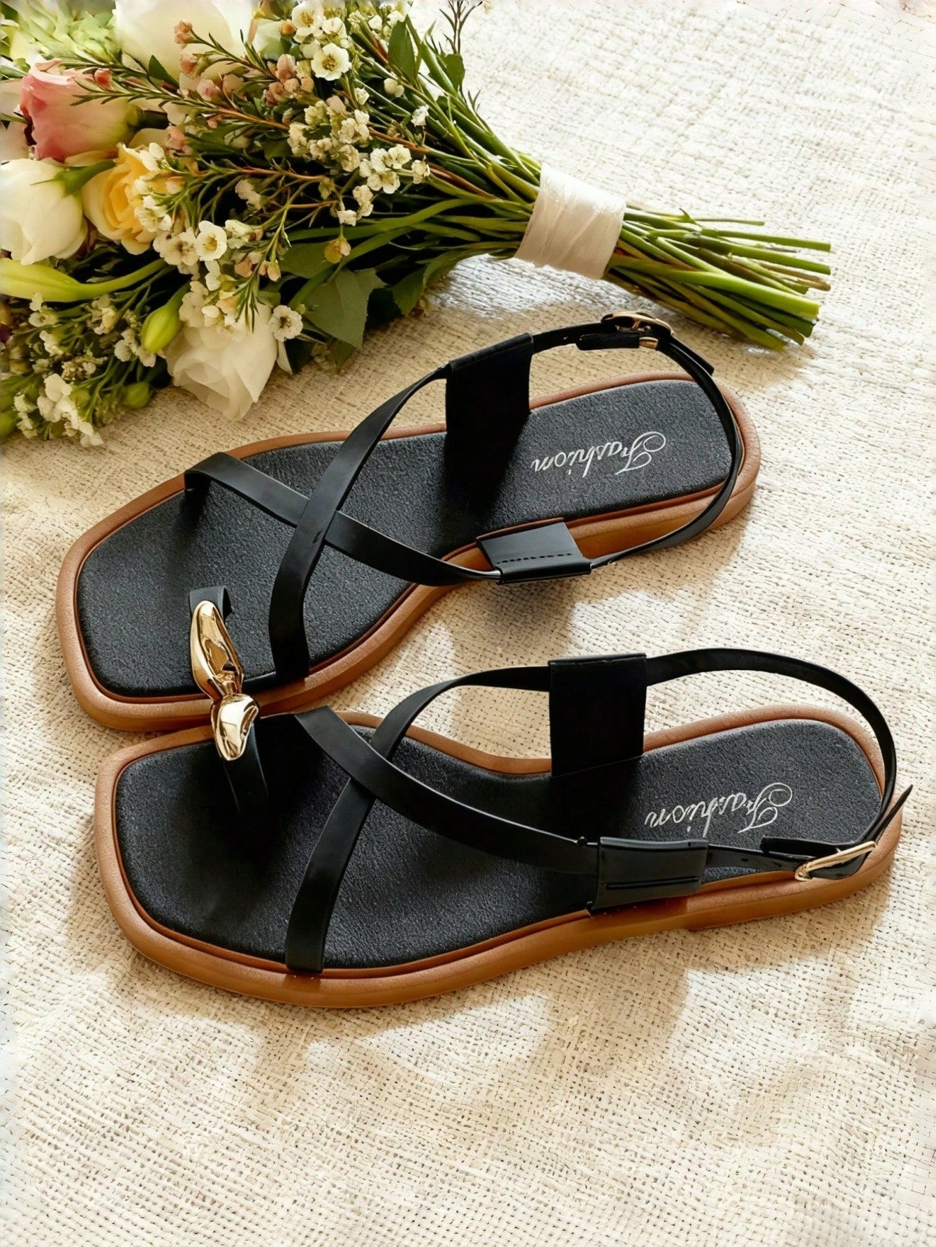 Women's white flat slide sandals featuring criss cross straps, shell detail, and buckle accents