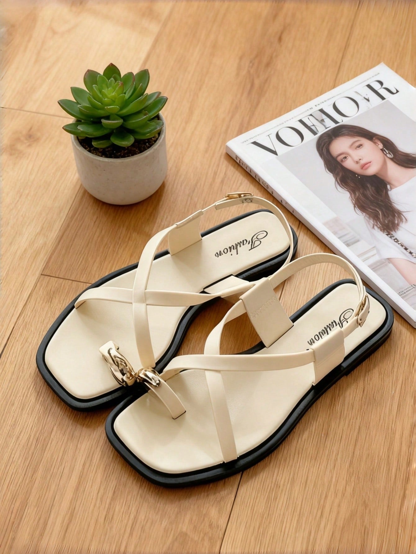 Women's white flat slide sandals featuring criss cross straps, shell detail, and buckle accents