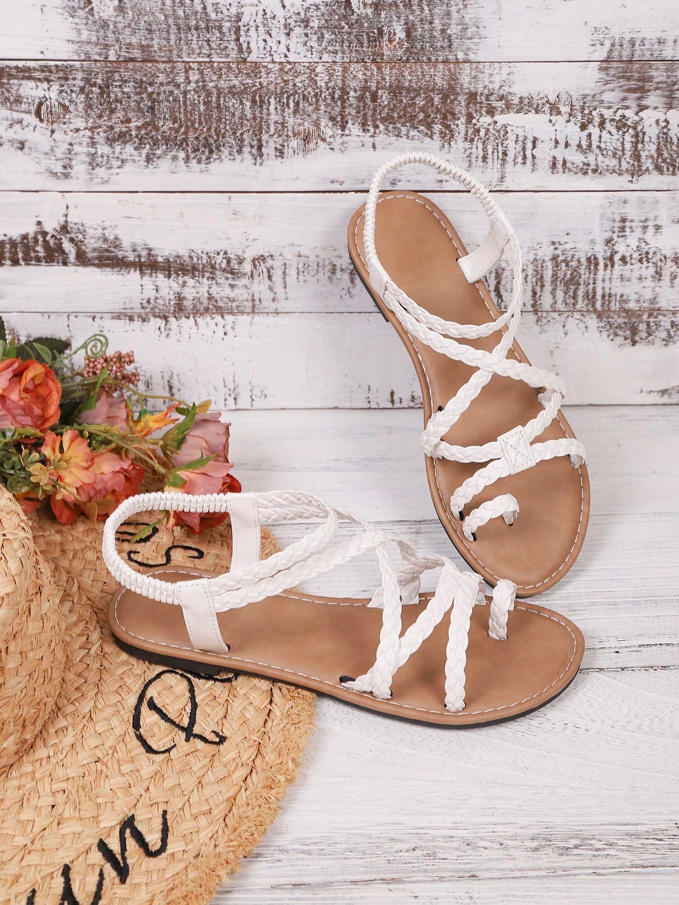 Women's woven criss-cross elastic flat sandals with braided strappy upper and toe post design
