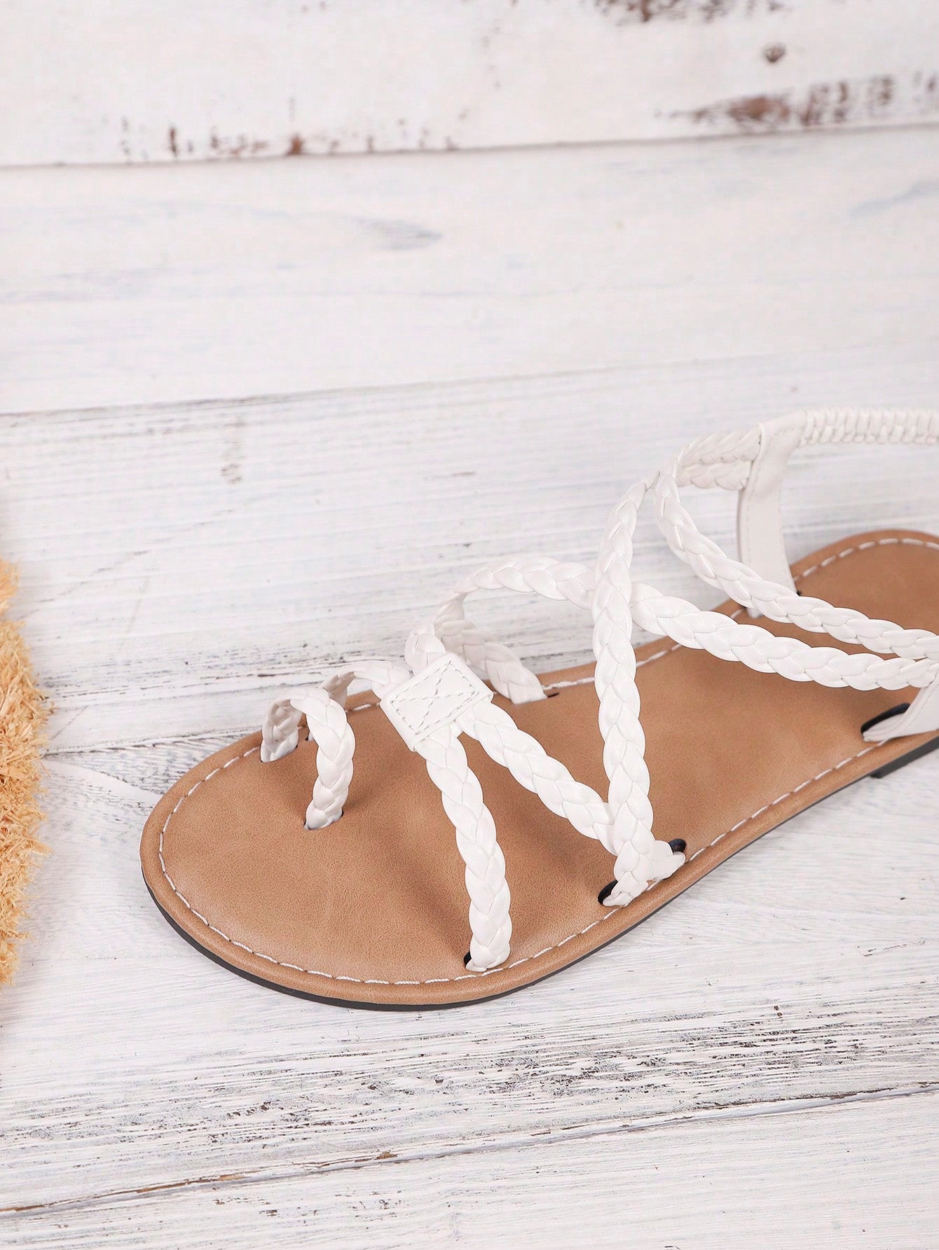 Women's woven criss-cross elastic flat sandals with braided strappy upper and toe post design