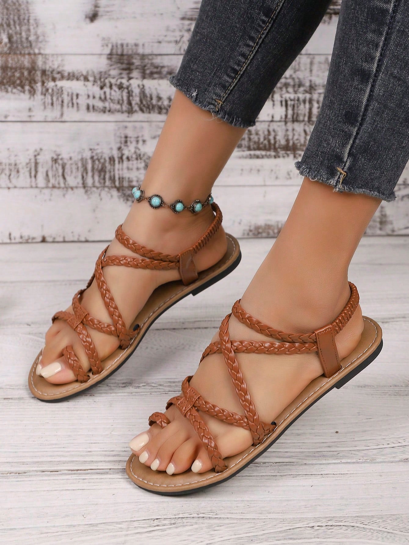 Women's woven criss-cross elastic flat sandals with braided strappy upper and toe post design