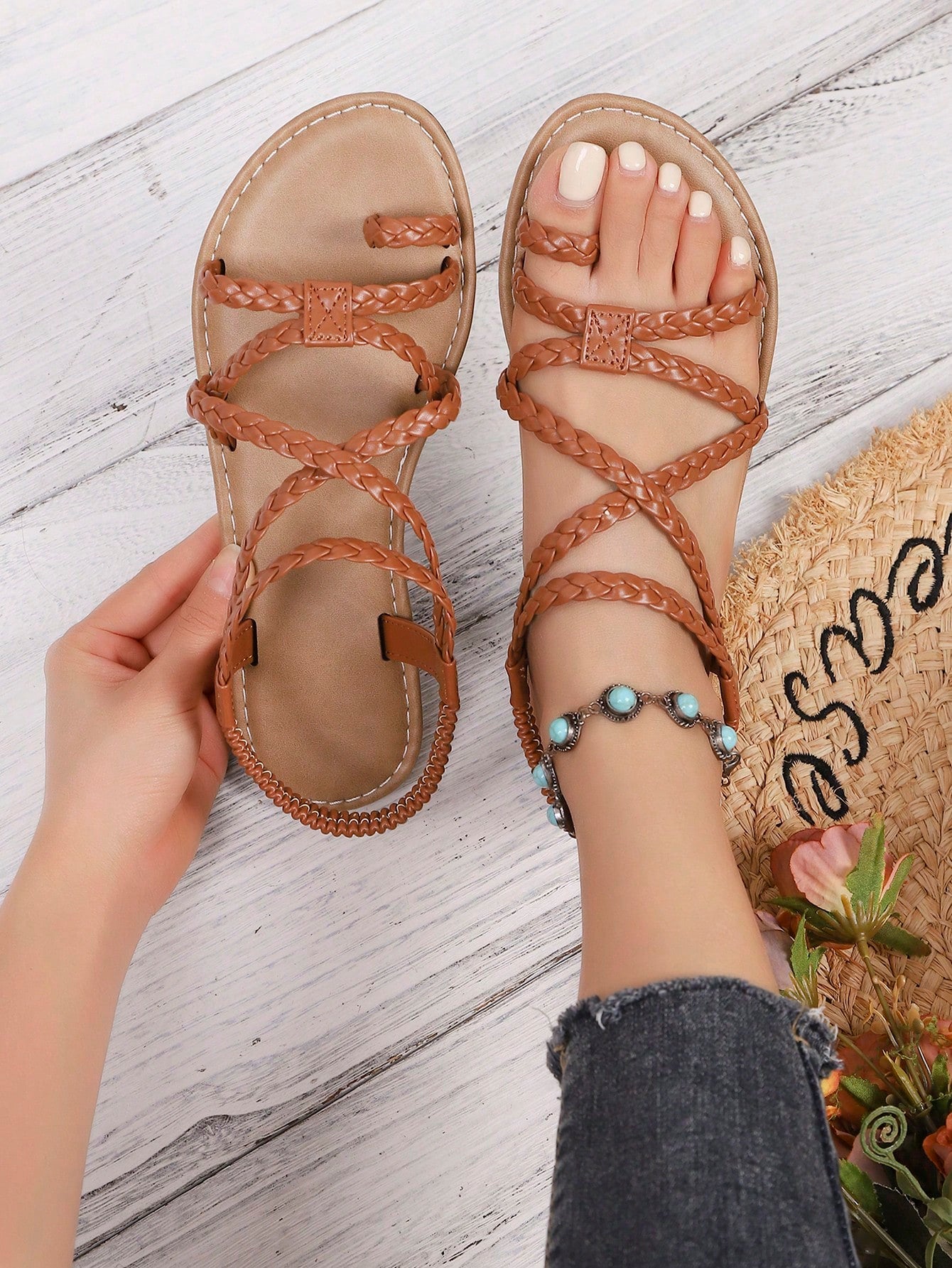 Women's woven criss-cross elastic flat sandals with braided strappy upper and toe post design