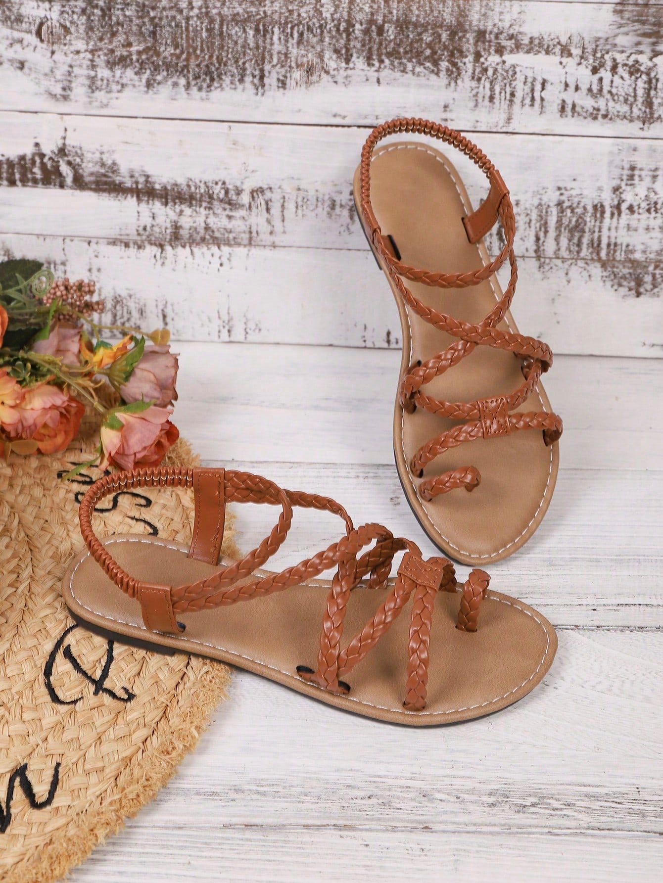 Women's woven criss-cross elastic flat sandals with braided strappy upper and toe post design