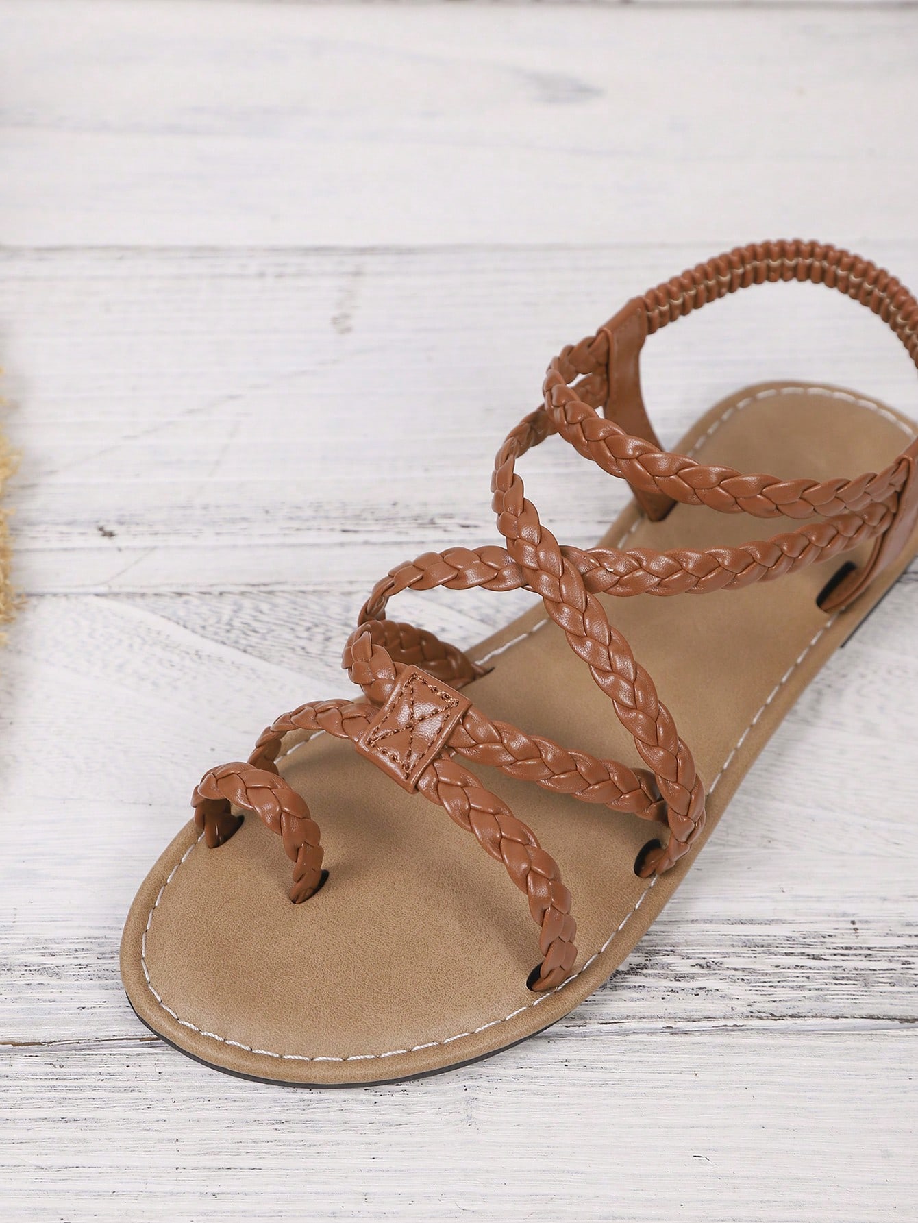 Women's woven criss-cross elastic flat sandals with braided strappy upper and toe post design