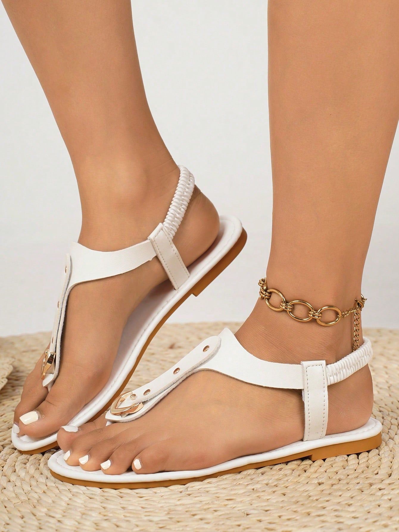Women's flat slide sandals with rivet decor, elastic strap, buckle detail, and toe post open design for outdoor and beach wear.