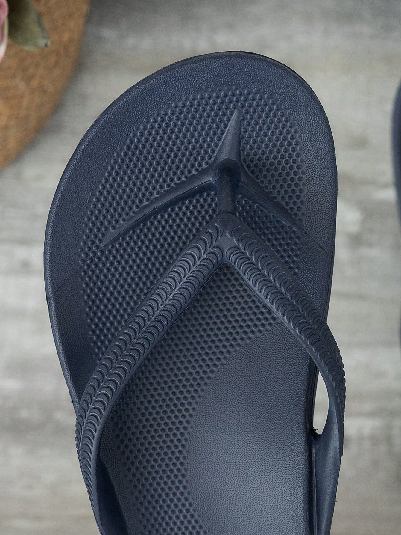 Women's solid color flip flops with open-toe design, flat sole, and cut-out details, suitable for casual indoor or outdoor wear at the beach or pool.