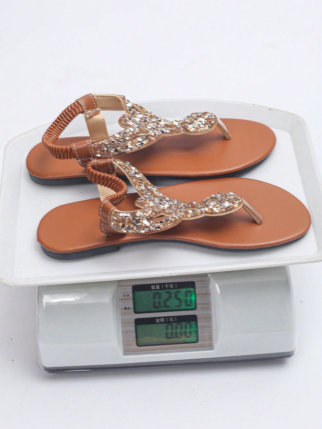 Women’s plus size 35-45 flat thong sandals with elastic strap, round toe shape, textured pattern, and rhinestone asymmetrical detail in slip-on beach style for outdoor summer wear.