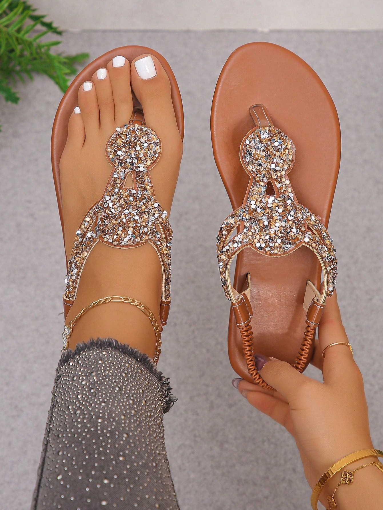 Women’s plus size 35-45 flat thong sandals with elastic strap, round toe shape, textured pattern, and rhinestone asymmetrical detail in slip-on beach style for outdoor summer wear.