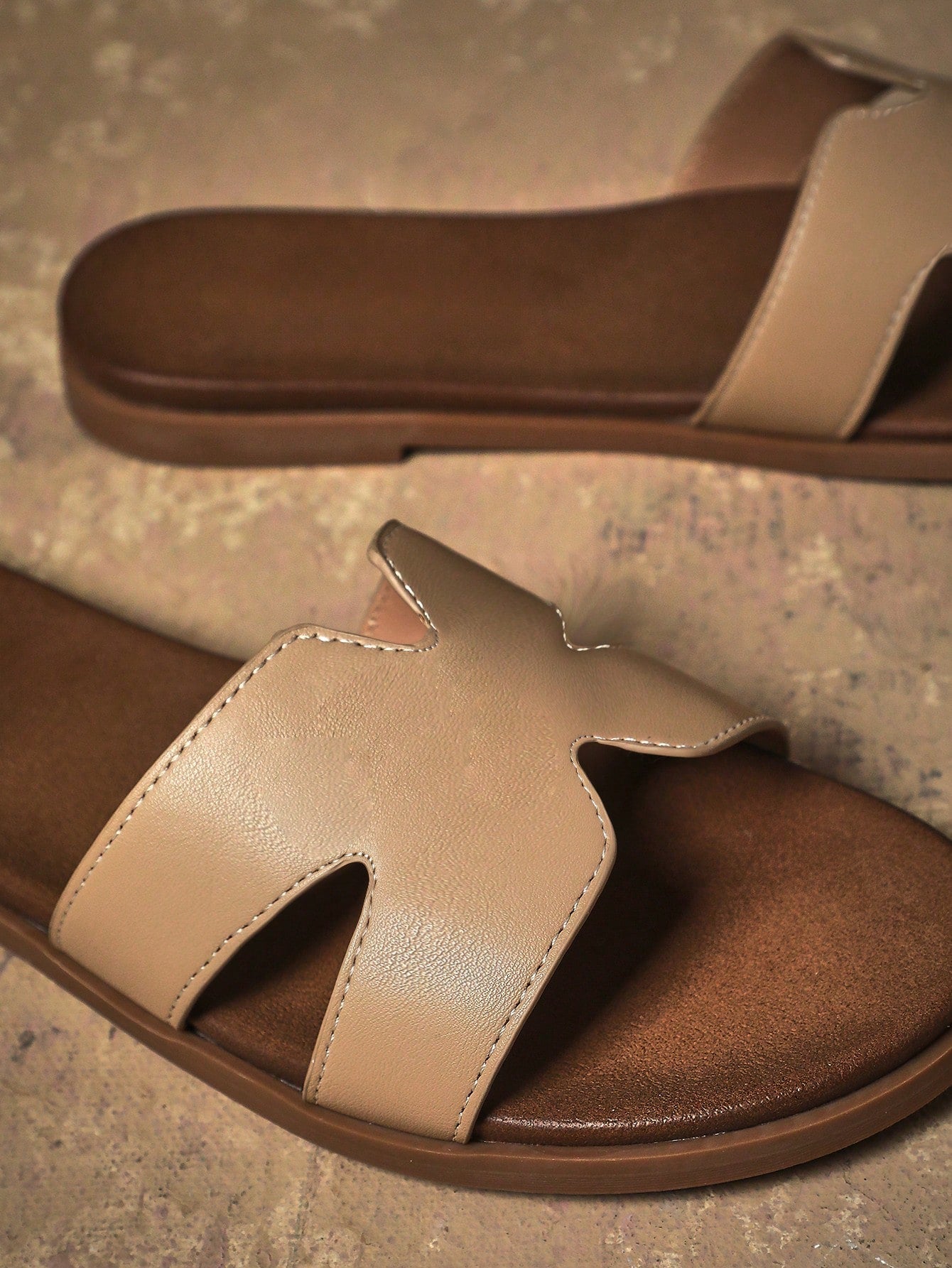 Women's flat slide sandals with supportive PU midsole, harness-style cutout detail, and open toe design.