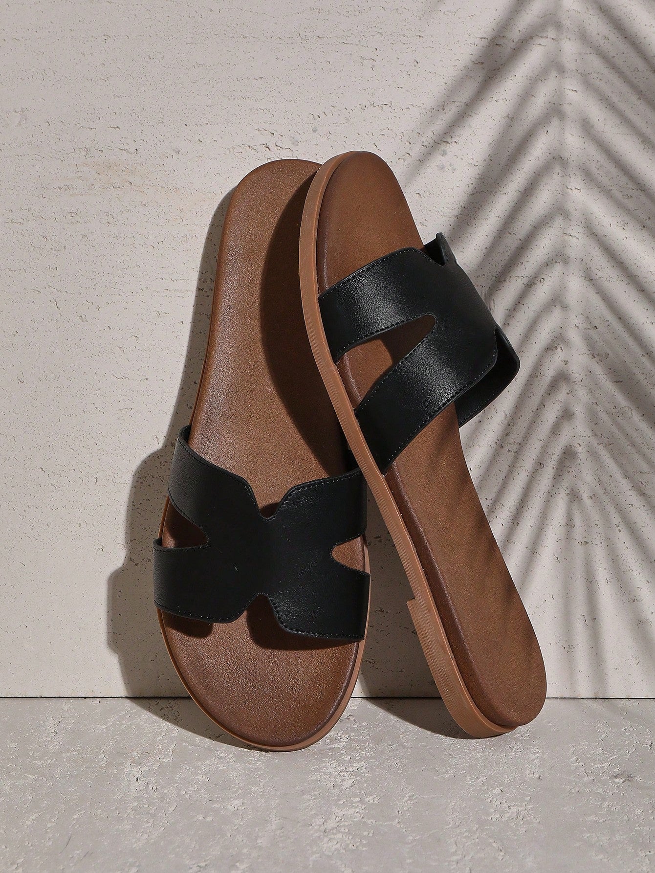 Women's flat slide sandals with supportive PU midsole, harness-style cutout detail, and open toe design.