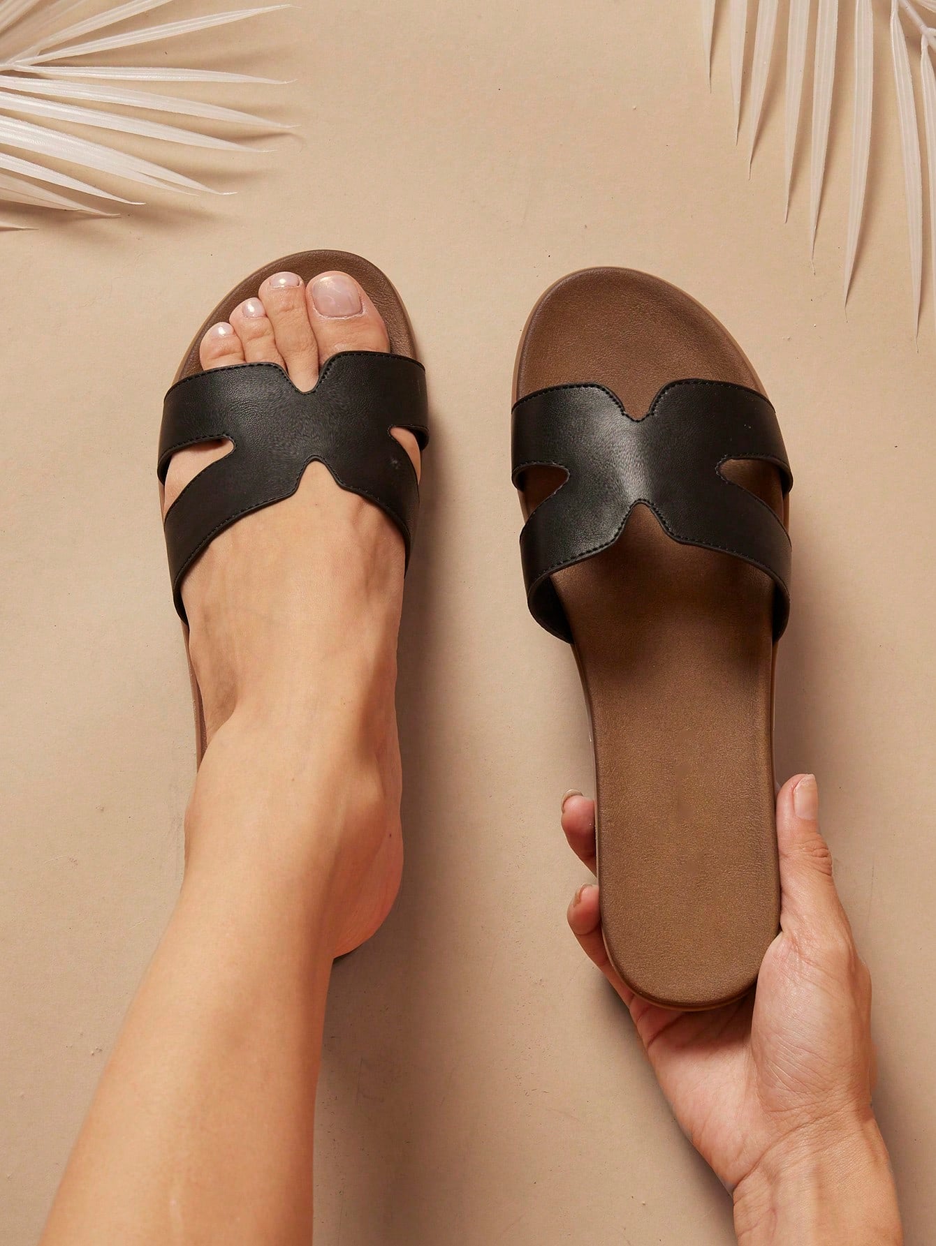 Women's flat slide sandals with supportive PU midsole, harness-style cutout detail, and open toe design.