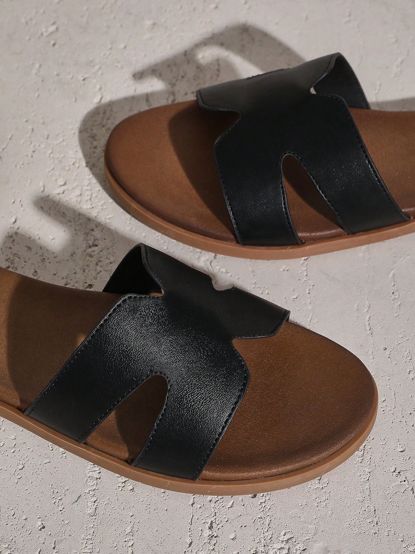 Women's flat slide sandals with supportive PU midsole, harness-style cutout detail, and open toe design.