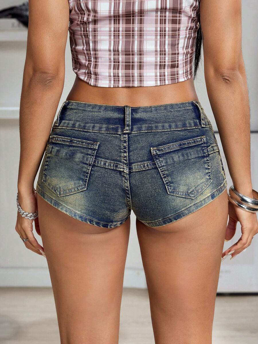 Women's petite Y2K medium wash mini shorts with ripped details, random print accents, zipper fly, mid waist, and skinny straight-leg fit.
