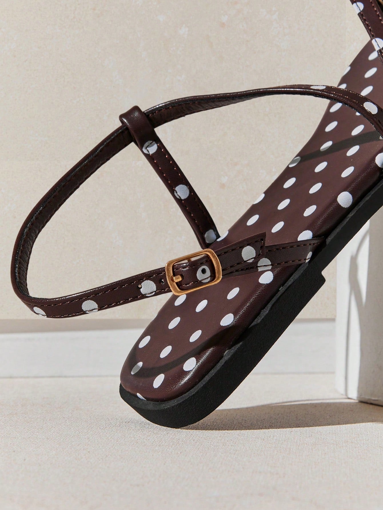 Women's flat open-toe sandals featuring a buckle detail and PU leather construction with a flat sole.