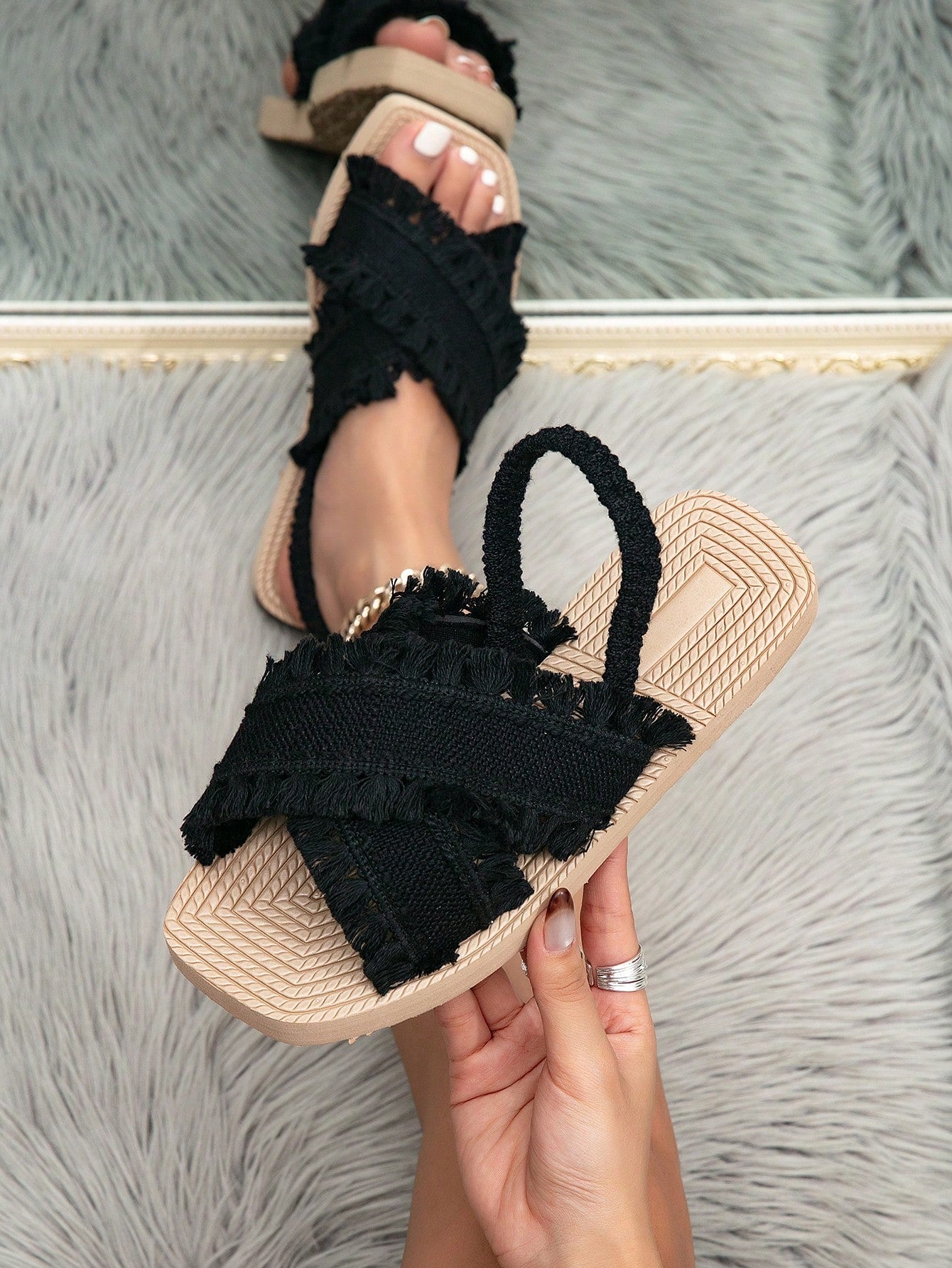 Women's white open-toe flat slide sandals featuring ruched fabric, bow accent, and fringe detail in a minimalist retro style.