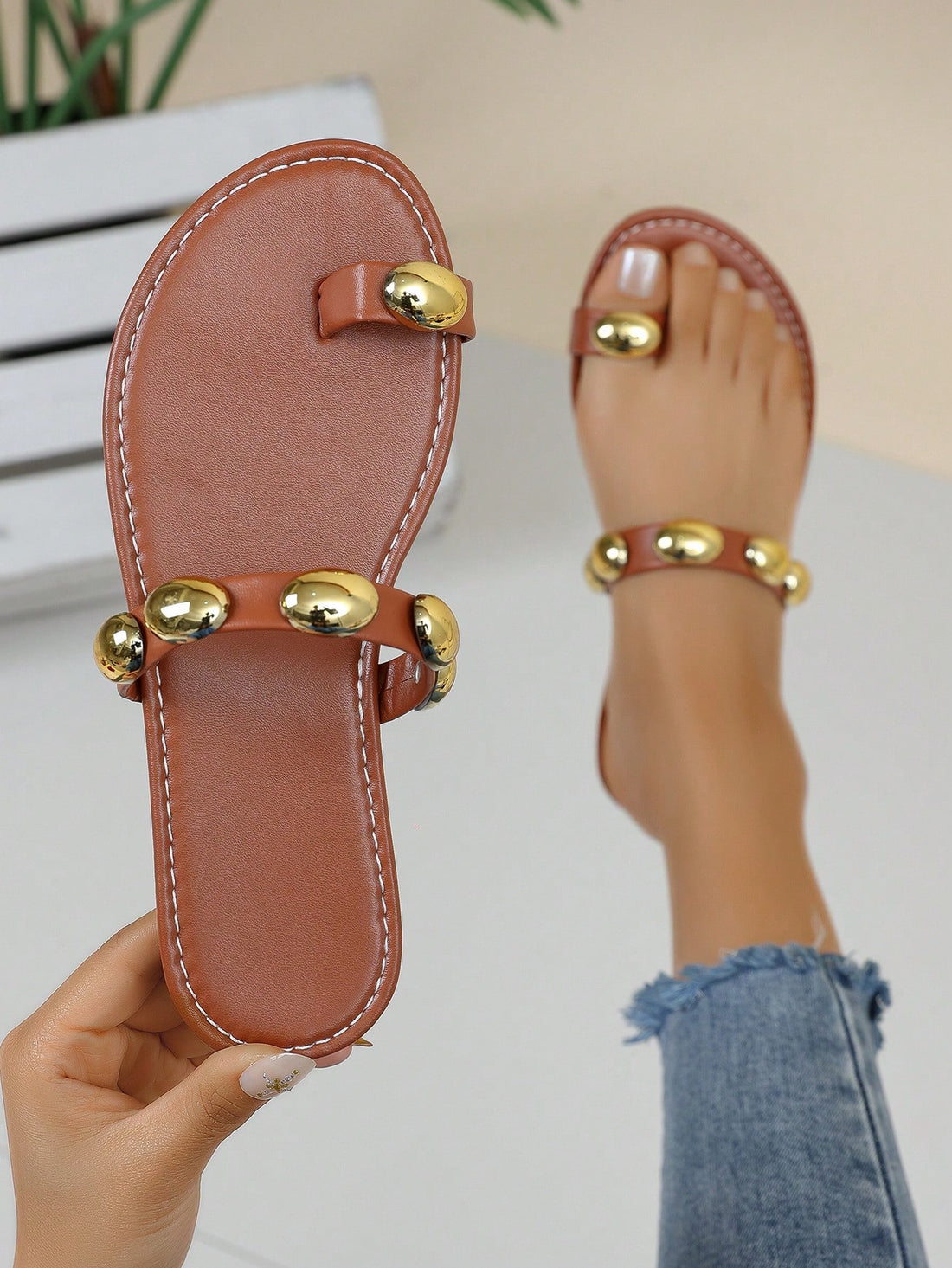 Women's brown flat toe-post sandals with beaded bohemian styling, plant pattern details, metal accents, and a PU leather upper, shown as a classic beach sandal.