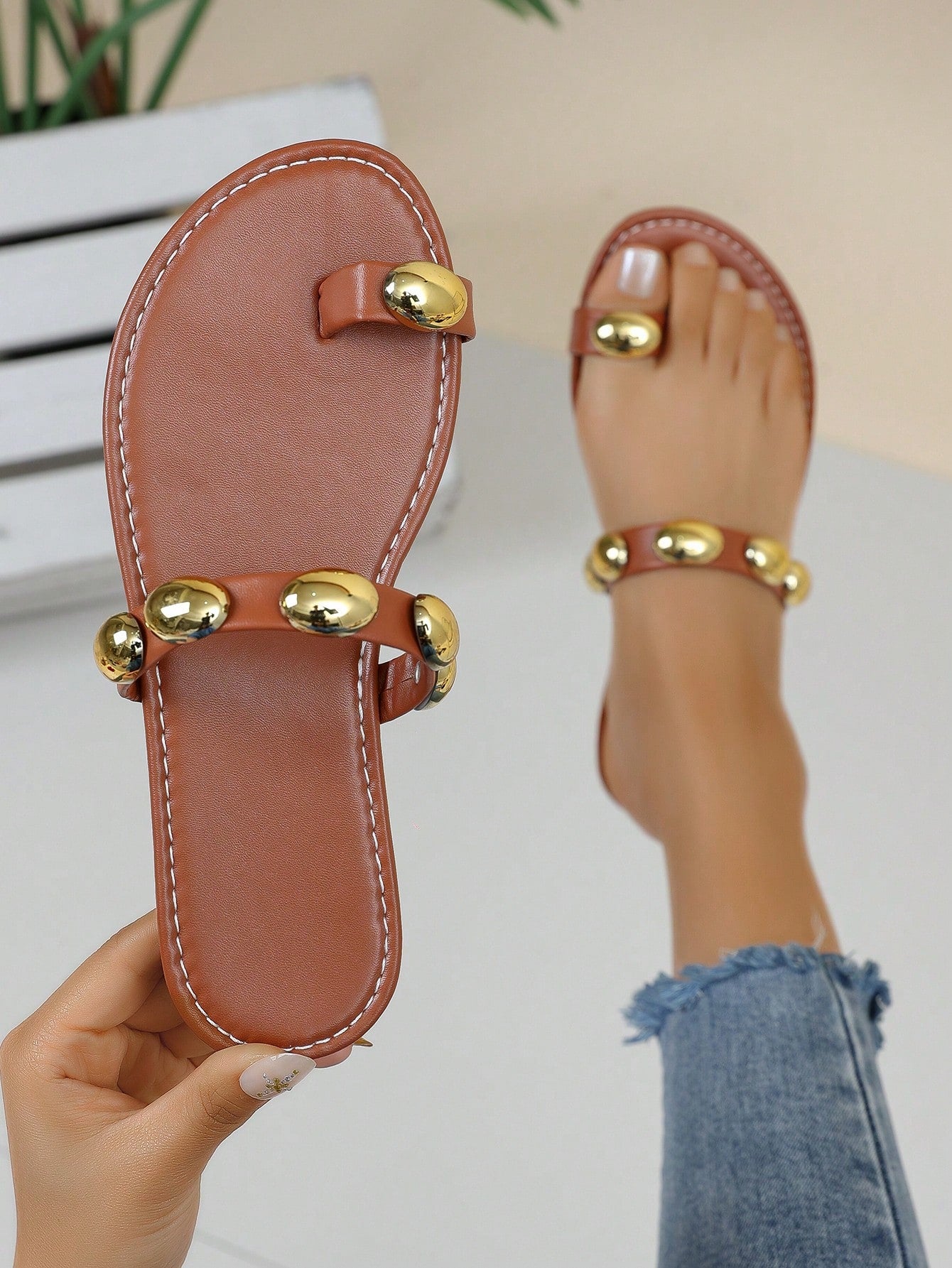 Women's brown flat toe-post sandals with beaded bohemian styling, plant pattern details, metal accents, and a PU leather upper, shown as a classic beach sandal.