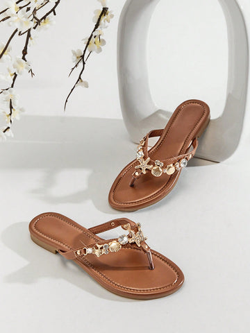 Women's flat toe post thong sandals with sea shell and starfish decoration, slide-style design, PU leather upper and TPR outsole.