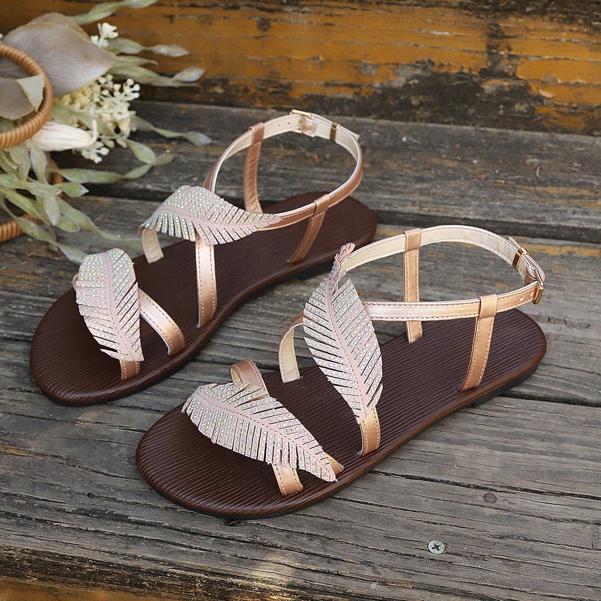 Women's flat sandals with strappy rope-detail design, plant pattern, and open-toe silhouette.