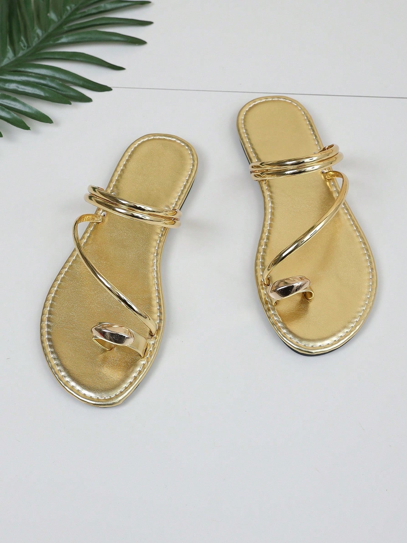 Women's leopard braided flat thong sandals with toe post and metal detail, designed for beach and vacation casual wear.
