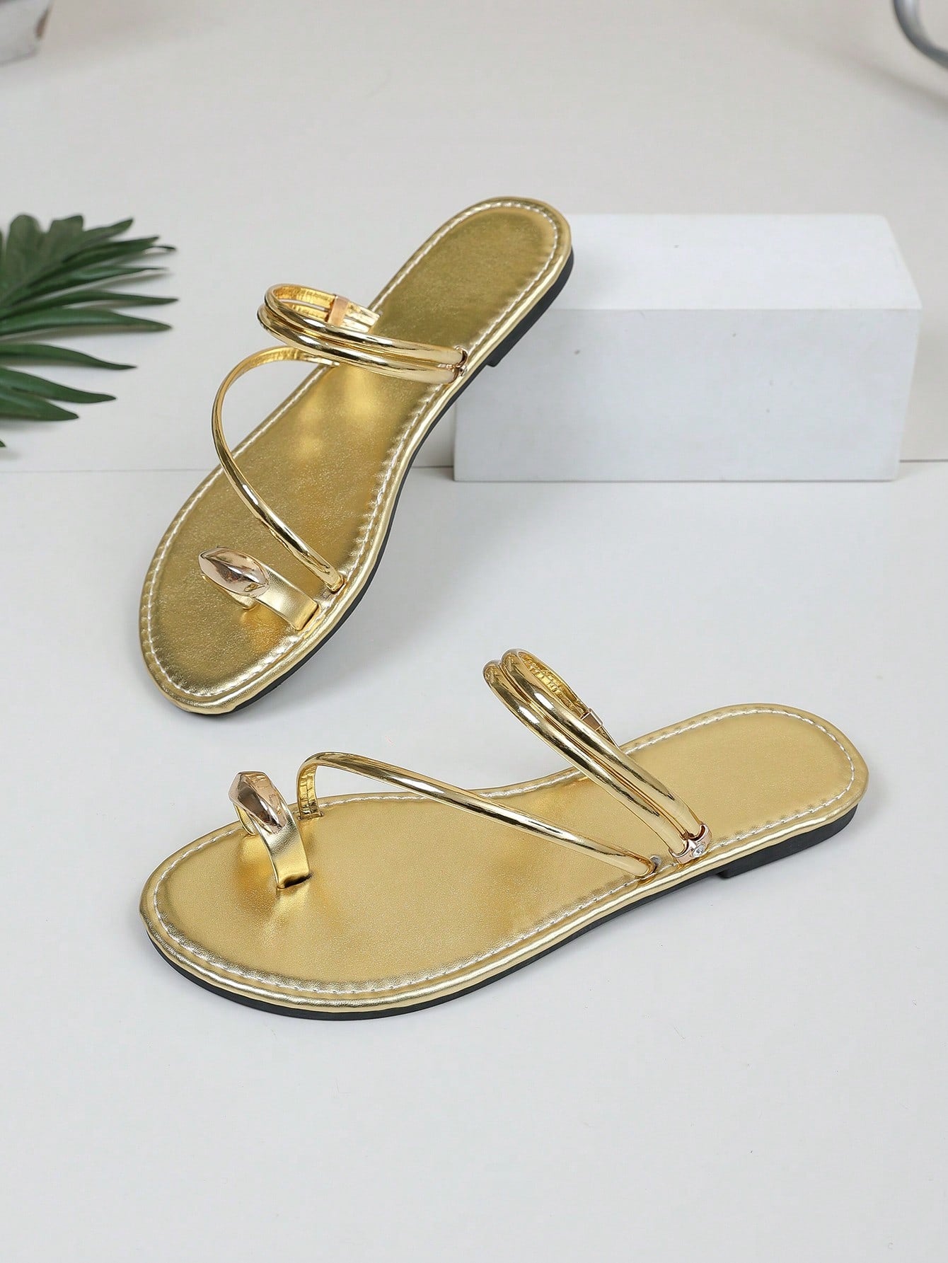 Women's leopard braided flat thong sandals with toe post and metal detail, designed for beach and vacation casual wear.