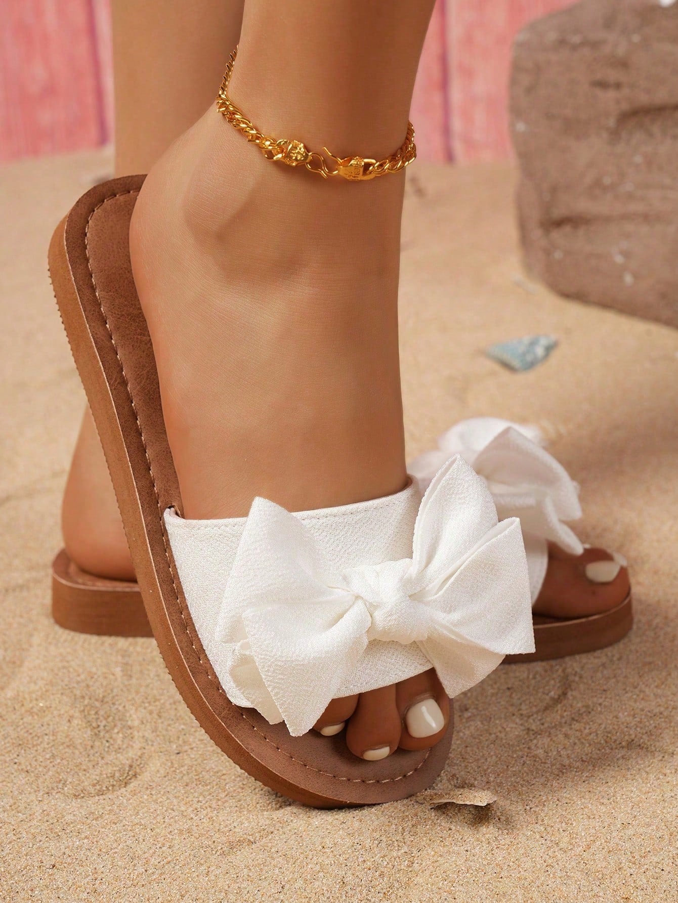 Brown vintage chic flip flops with metal shell decor, toe-post slide design, criss cross straps, and wedge sole for casual beach and outdoor wear.