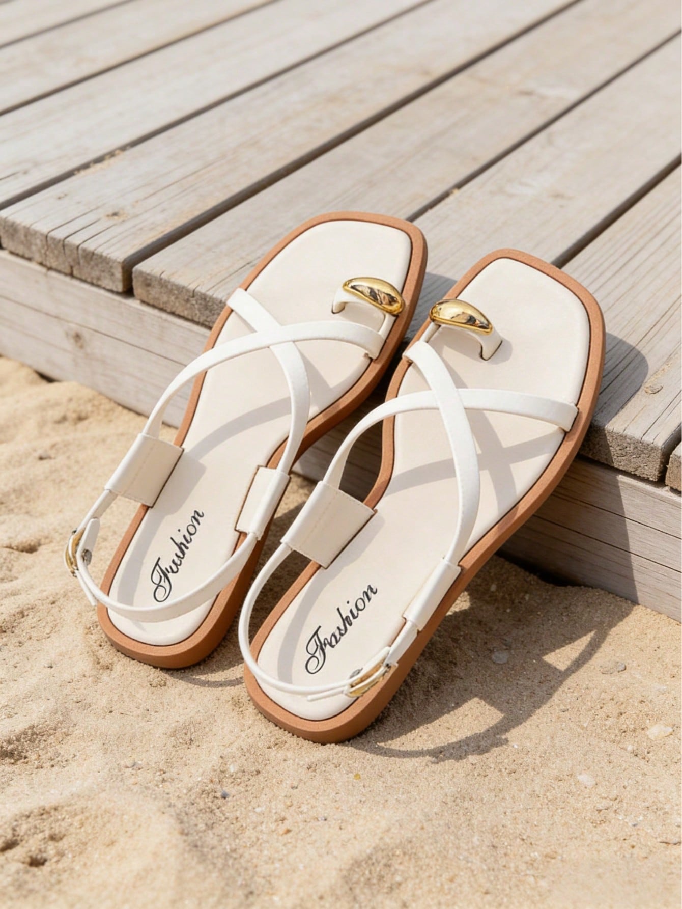 Women's flat toe-post sandals with cross-over straps and buckle detail, elegant outdoor style