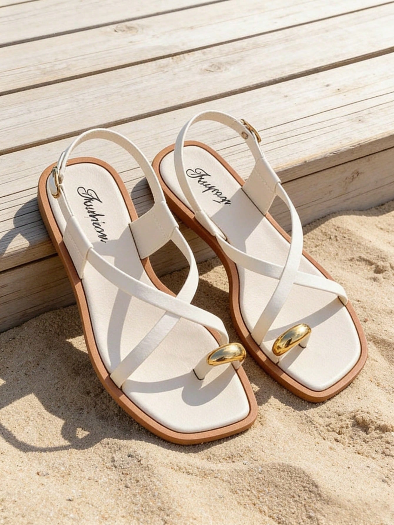 Women's flat toe-post sandals with cross-over straps and buckle detail, elegant outdoor style