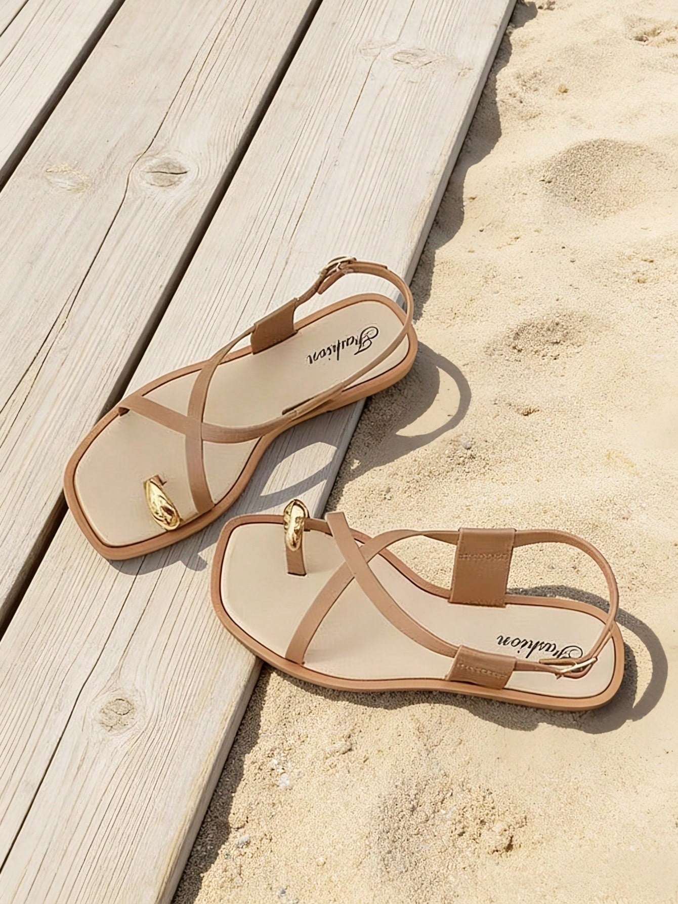 Women's flat toe-post sandals with cross-over straps and buckle detail, elegant outdoor style