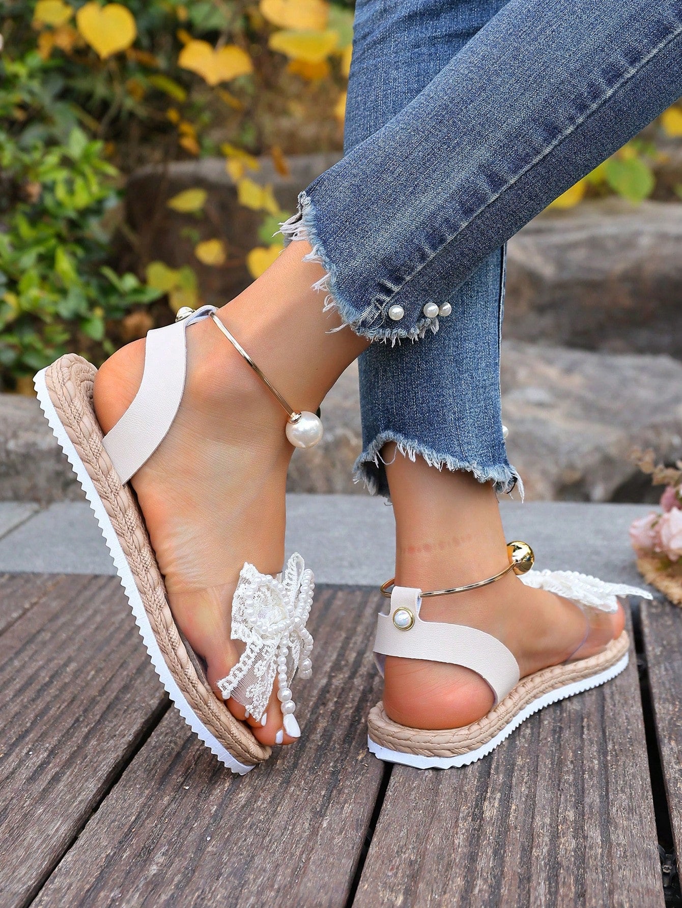 Women's open-toe flat slide sandals with transparent lace bow, pearl and flower decor, soft non-slip sole, and beach style design in beige.