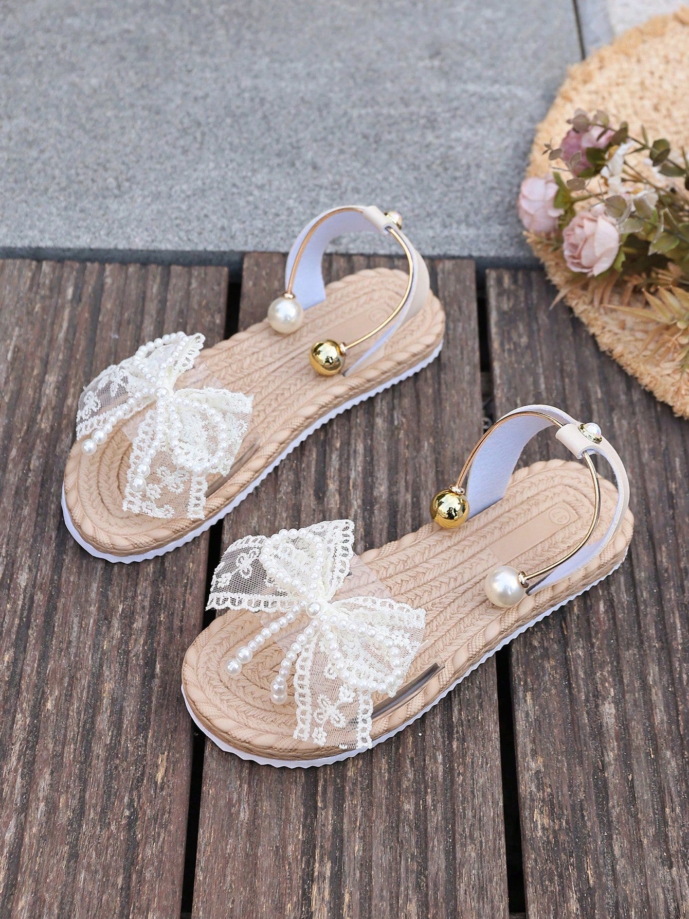 Women's open-toe flat slide sandals with transparent lace bow, pearl and flower decor, soft non-slip sole, and beach style design in beige.
