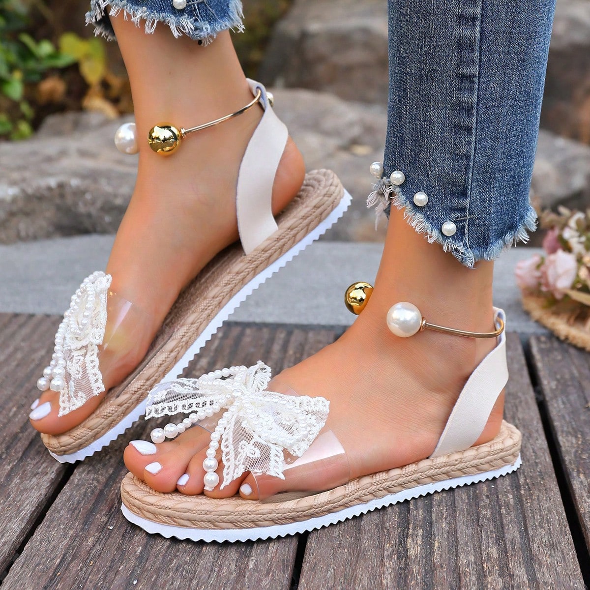 Women's open-toe flat slide sandals with transparent lace bow, pearl and flower decor, soft non-slip sole, and beach style design in beige.