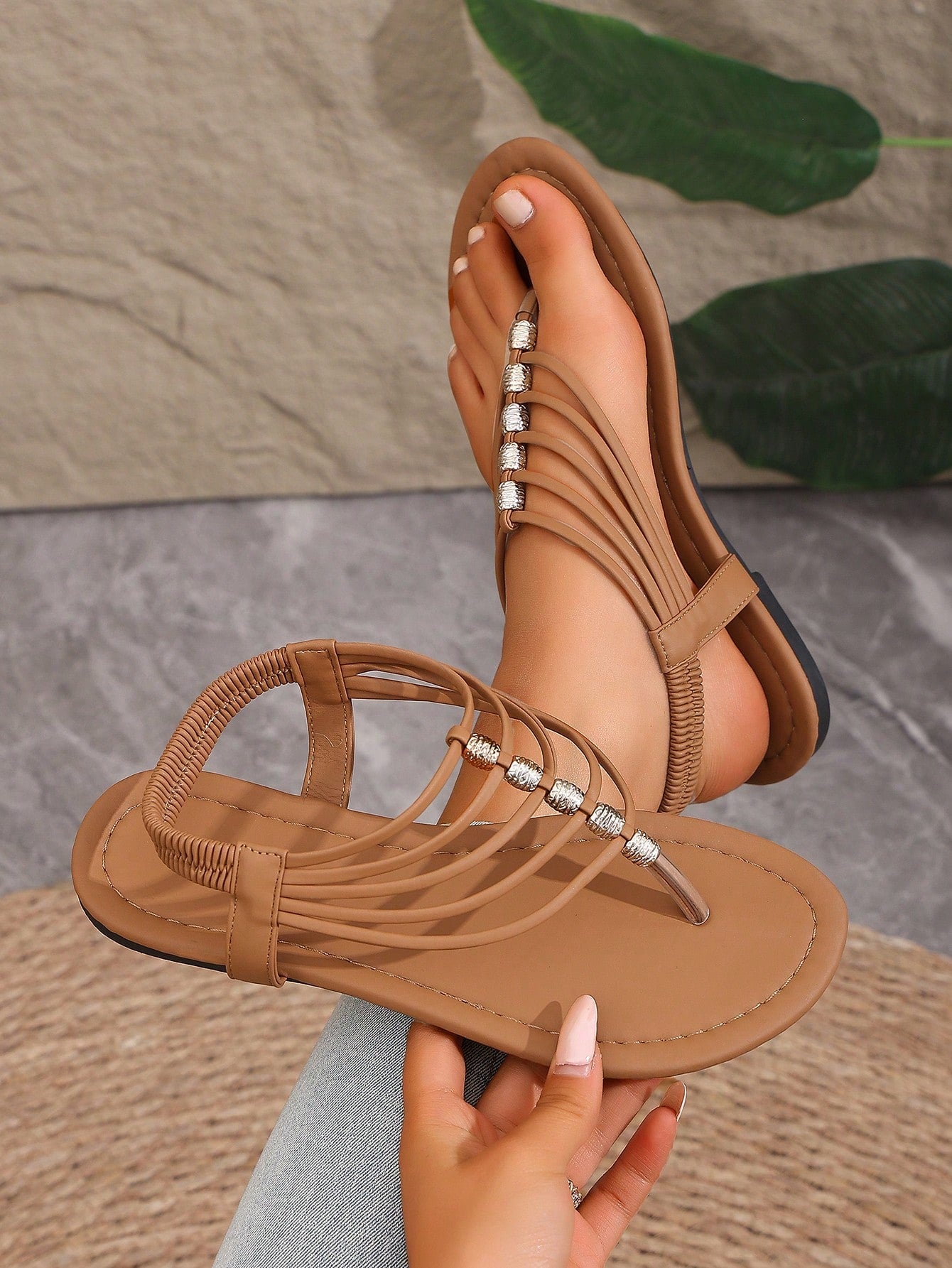 Women's boho flat sandals with elastic straps, braided beaded criss-cross detail, and toe post in gladiator style, suitable for beach, party, and outdoor summer wear.