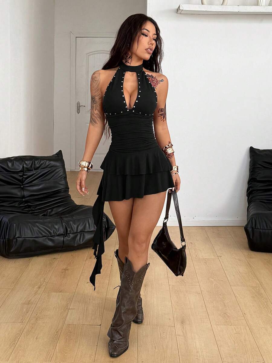 Women's black halter mini dress with a backless lace-up tie-back design, slim fit silhouette, high waist, sleeveless cut, and asymmetrical hem.