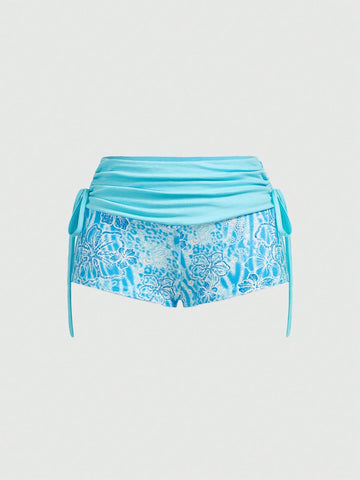 Women's low waist mini track shorts with elastic waistband, drawstring knot, ruched details, and plant pattern in a Y2K boho style