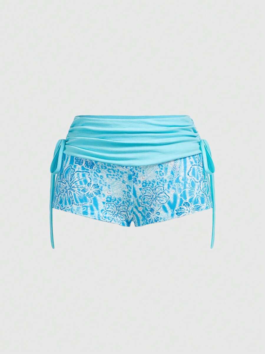 Women's low waist mini track shorts with elastic waistband, drawstring knot, ruched details, and plant pattern in a Y2K boho style