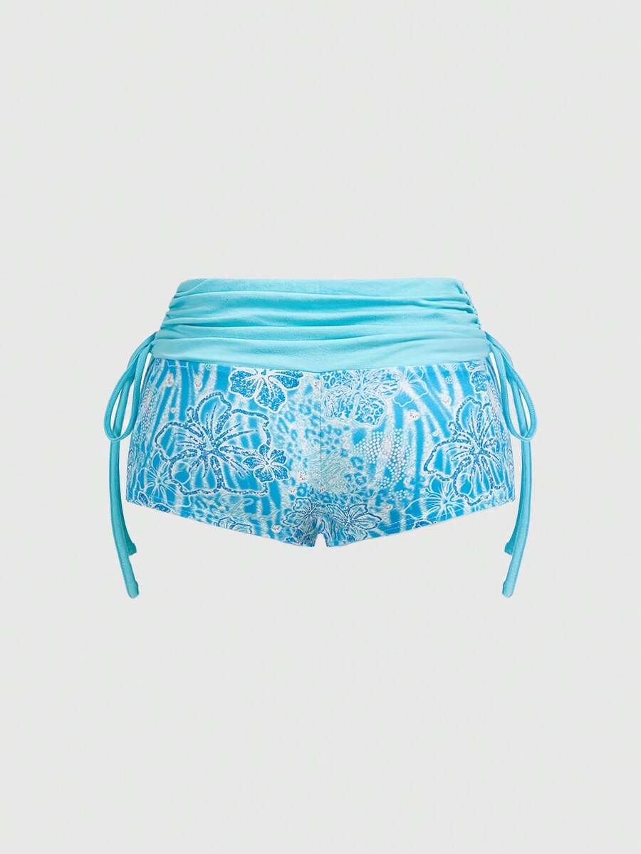 Women's low waist mini track shorts with elastic waistband, drawstring knot, ruched details, and plant pattern in a Y2K boho style