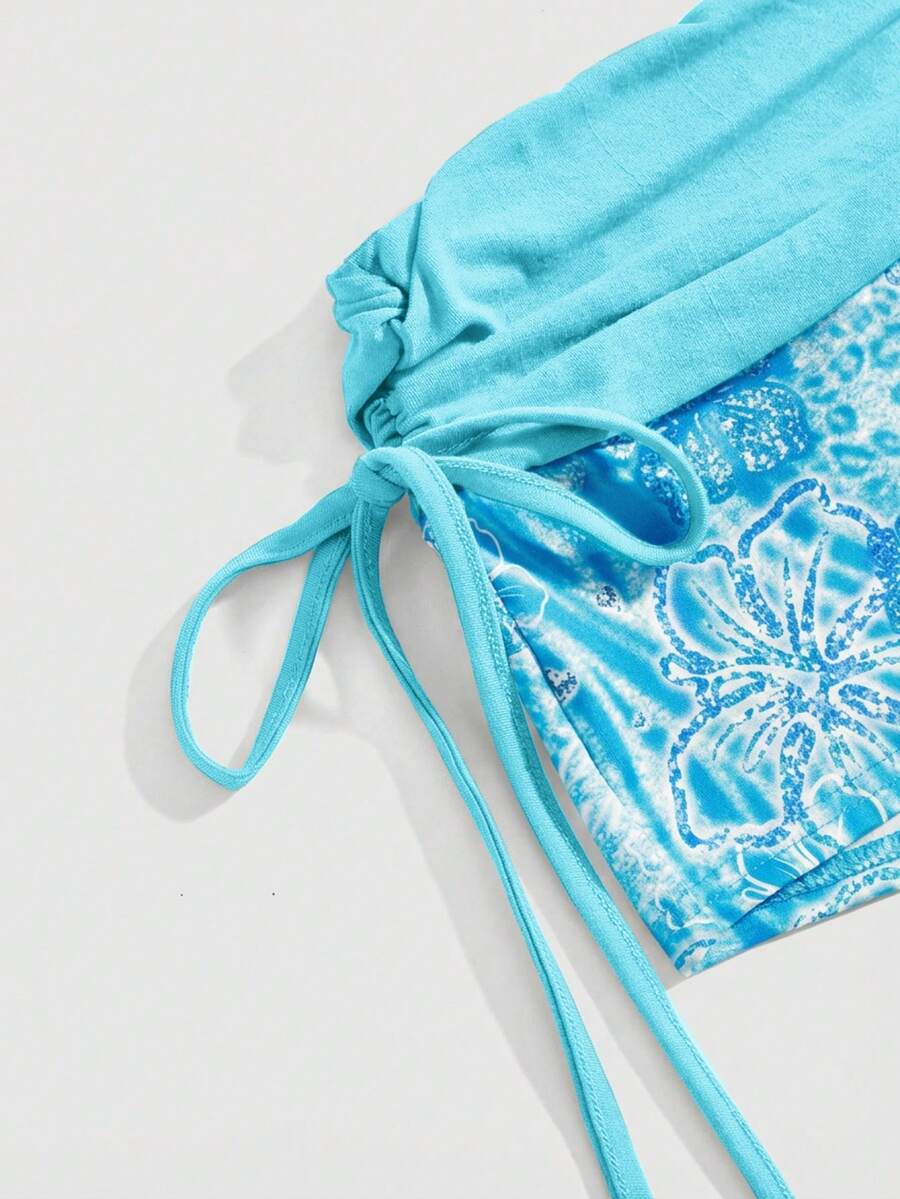 Women's low waist mini track shorts with elastic waistband, drawstring knot, ruched details, and plant pattern in a Y2K boho style