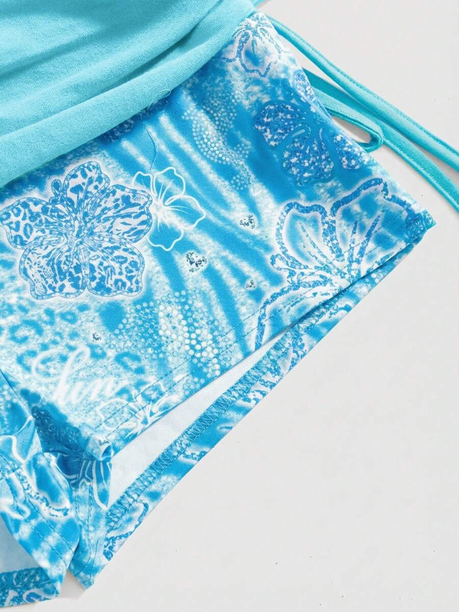 Women's low waist mini track shorts with elastic waistband, drawstring knot, ruched details, and plant pattern in a Y2K boho style