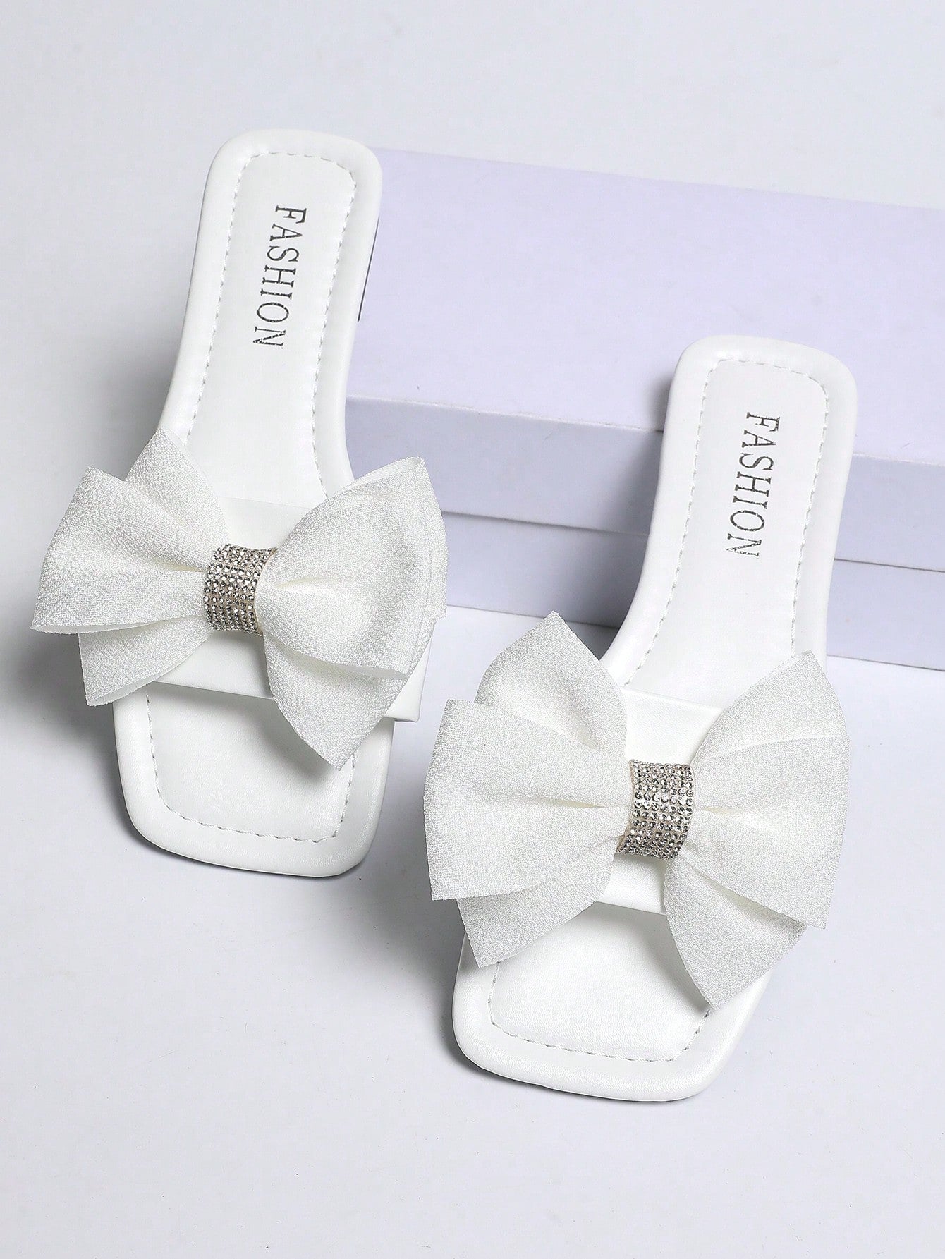 Women's khaki flat slide sandals with open toe, bow tie detail, and floral plant-pattern vacation style design.