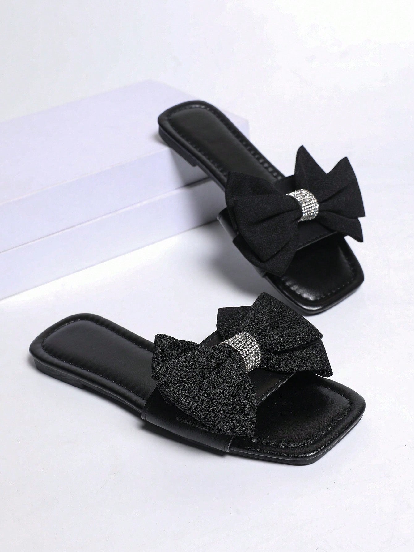 Women's khaki flat slide sandals with open toe, bow tie detail, and floral plant-pattern vacation style design.