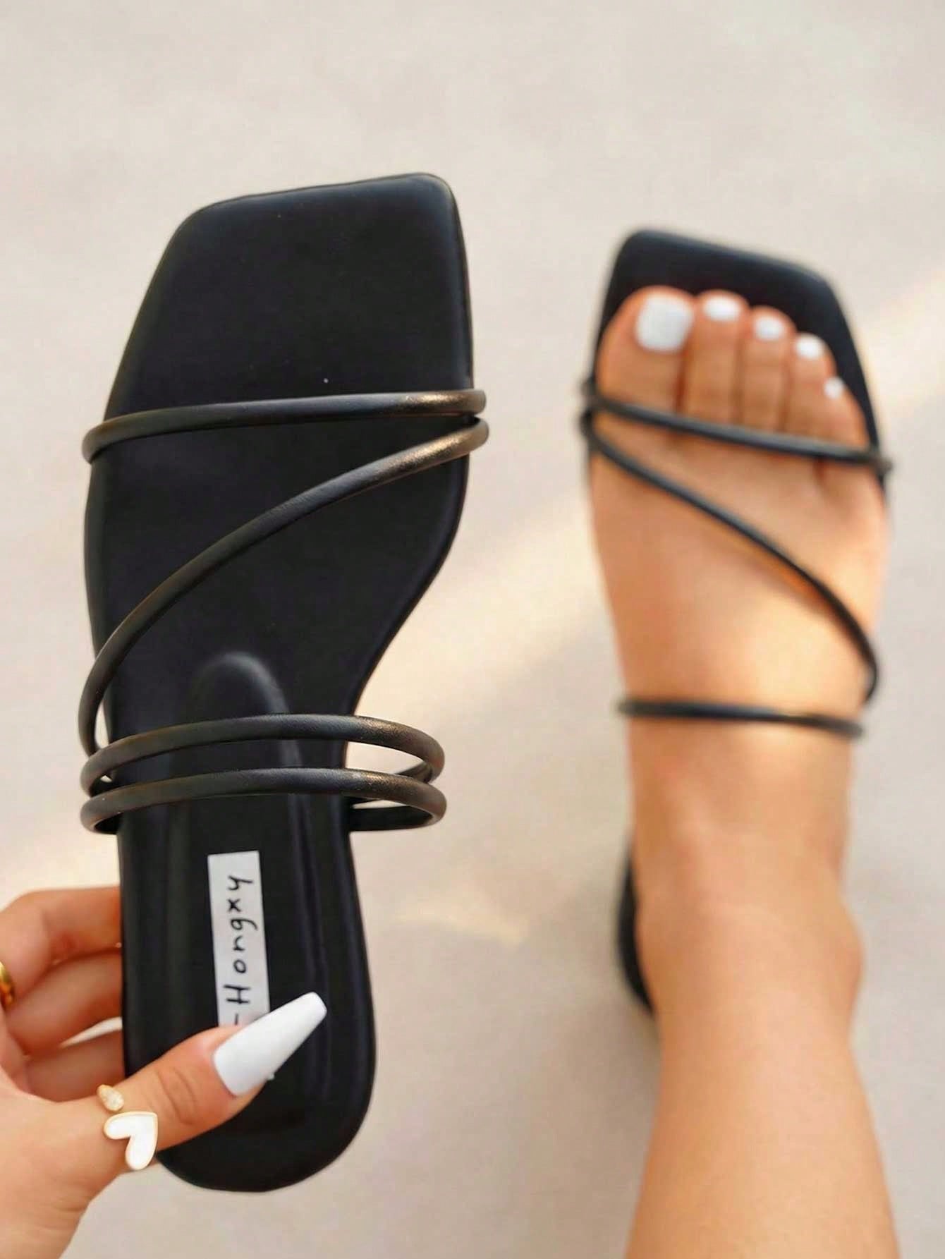 Women's slip-on flat slide sandals with bow tie decor, textured plain upper, and open toe.