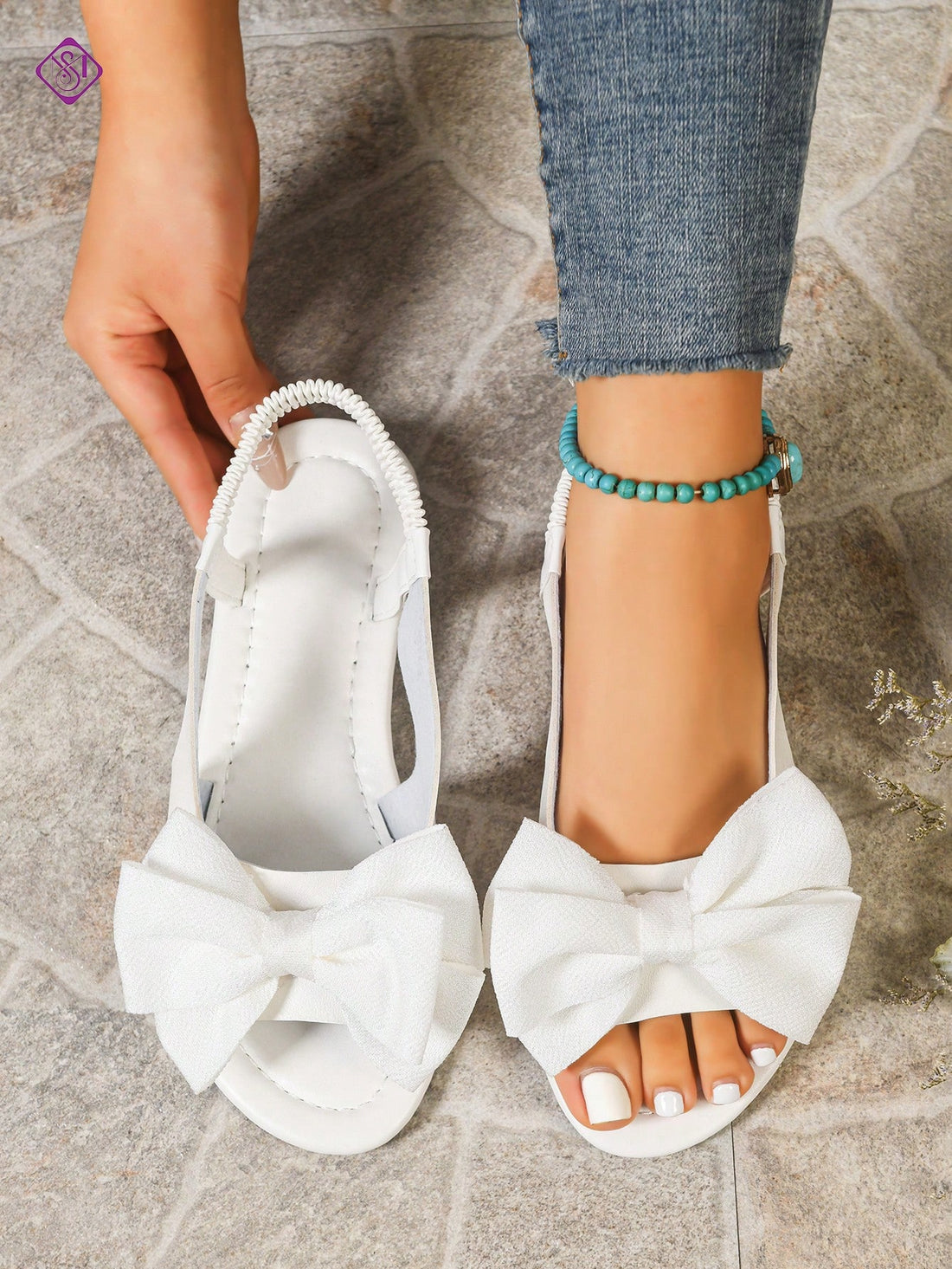 Women's wide width flat slip-on sandals with bow decor and open toe in a classic casual style