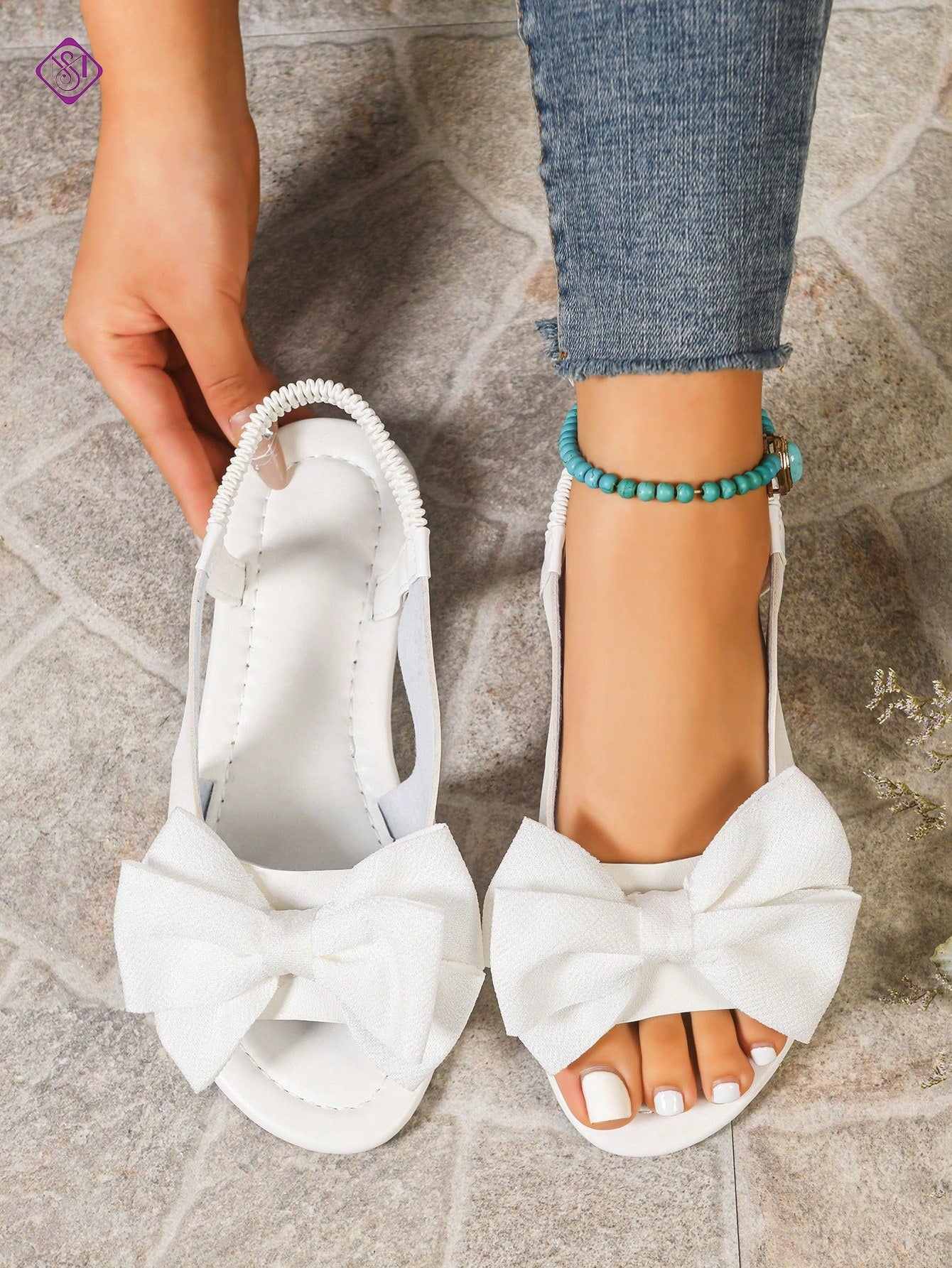 Women's wide width flat slip-on sandals with bow decor and open toe in a classic casual style