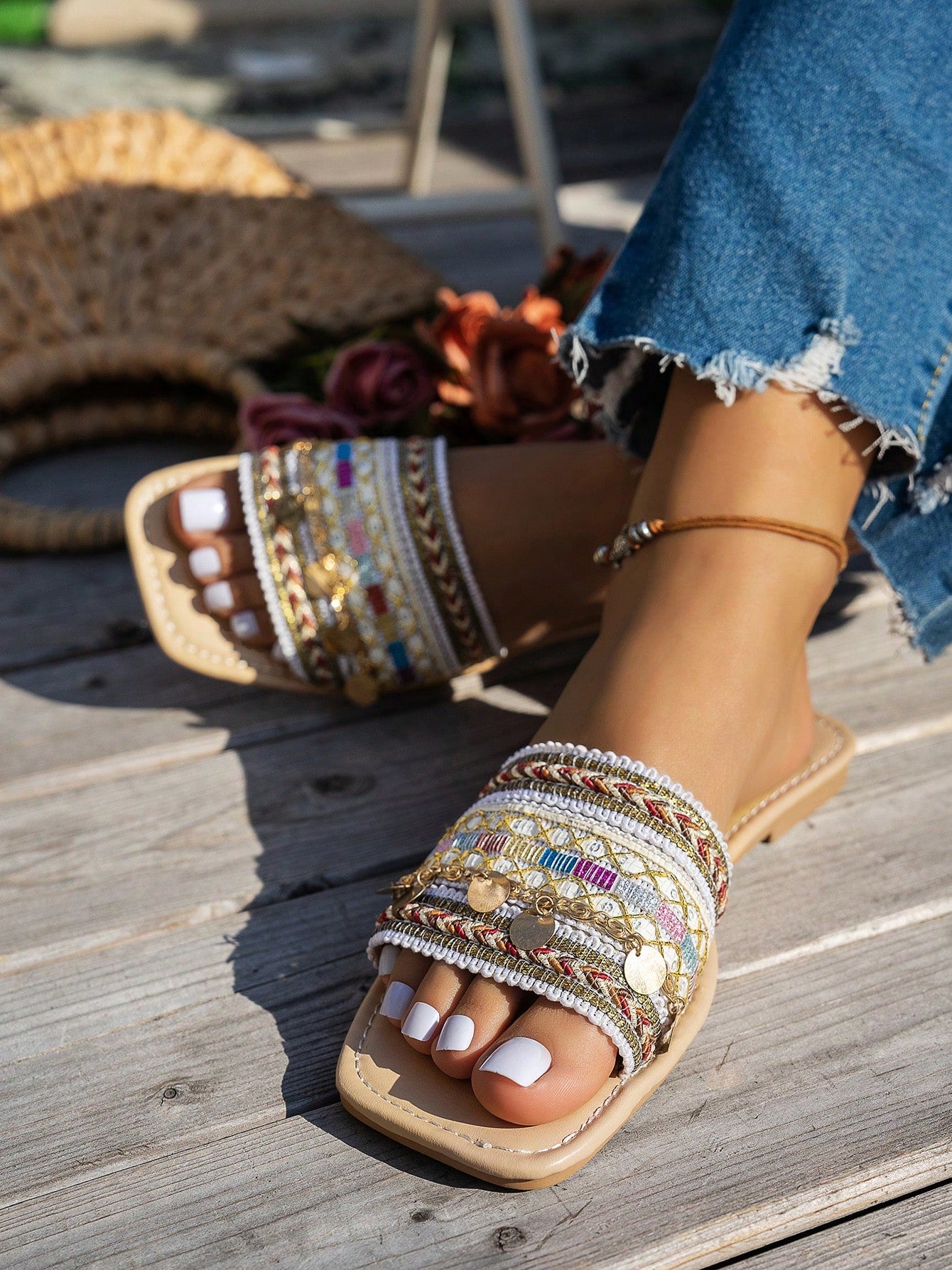 Pair of green women’s flat slide sandals with open toes, embroidered and beaded detailing, and fringe accents in a vacation style.