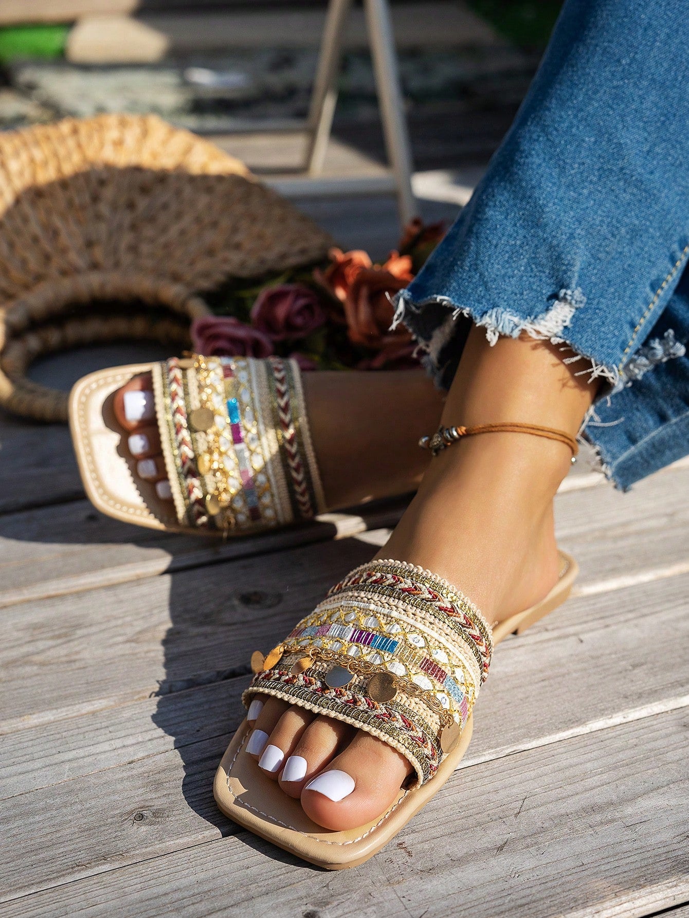 Pair of green women’s flat slide sandals with open toes, embroidered and beaded detailing, and fringe accents in a vacation style.