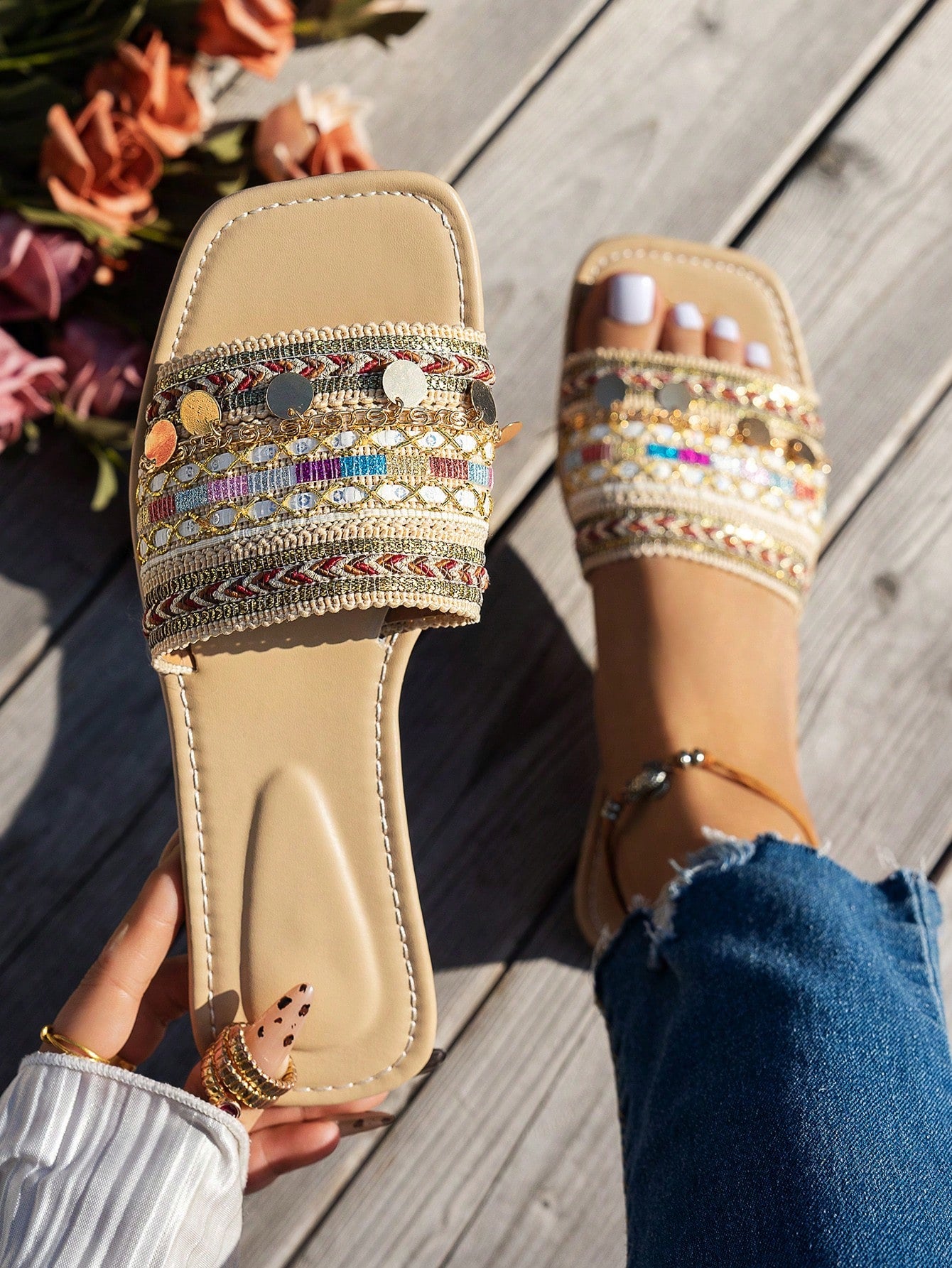 Pair of green women’s flat slide sandals with open toes, embroidered and beaded detailing, and fringe accents in a vacation style.