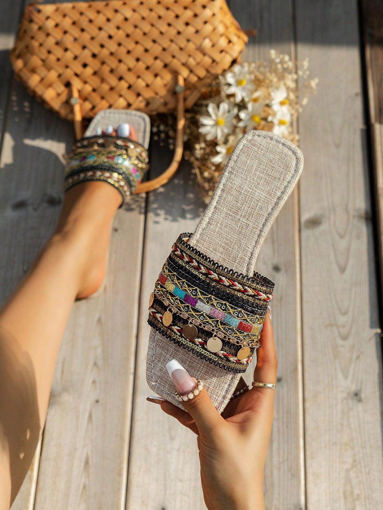 Pair of green women’s flat slide sandals with open toes, embroidered and beaded detailing, and fringe accents in a vacation style.