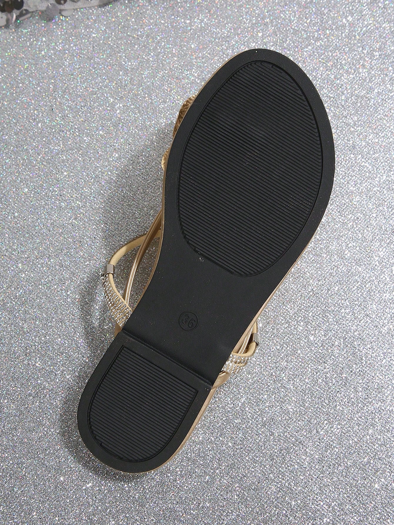 Women's flat slide sandals with open toe, floral applique detail, and criss-cross straps, shown as casual vacation-style summer footwear.