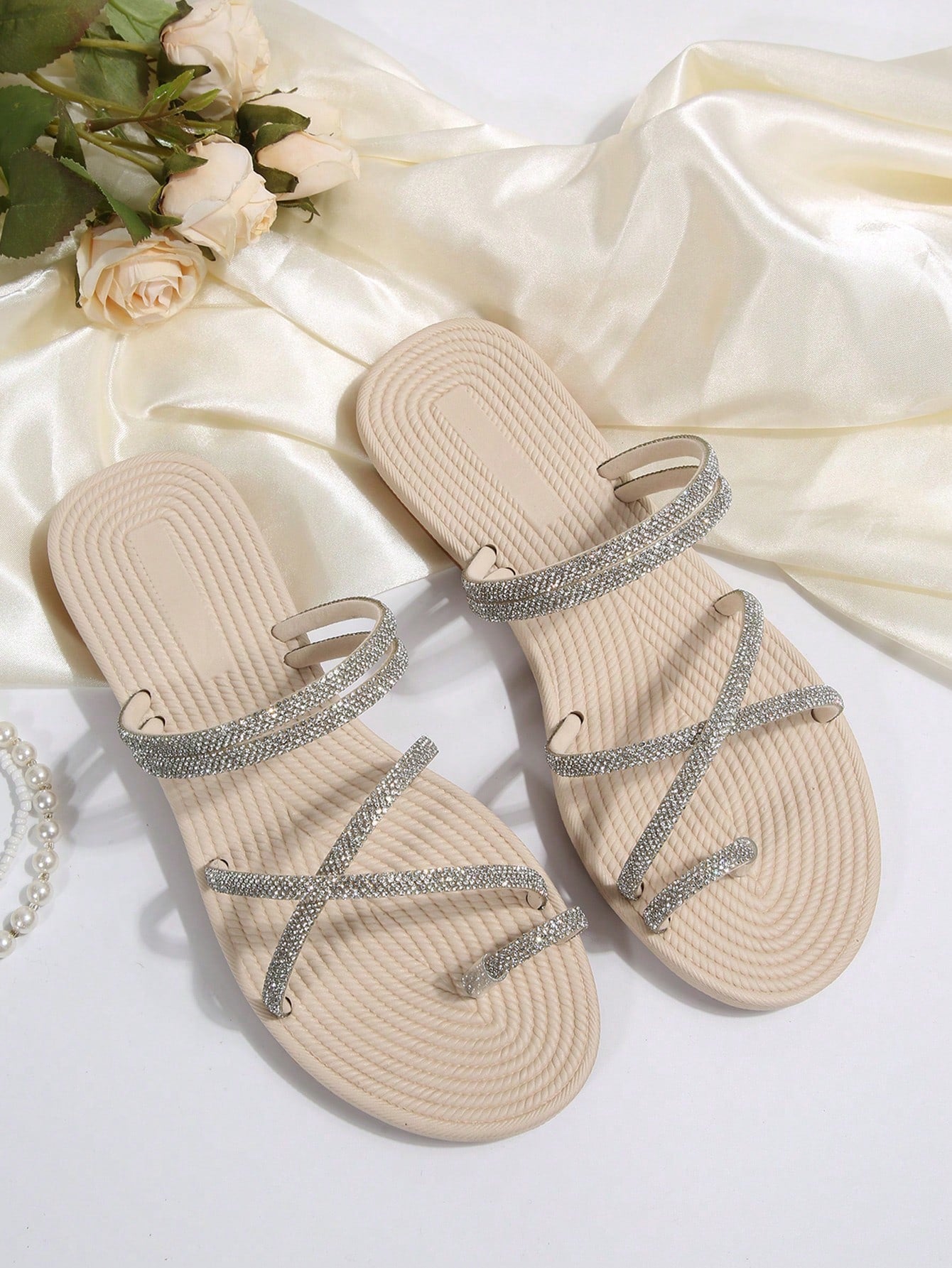 Women's open-toe strappy flat sandals with tasseled upper, seashell-inspired decoration, and rhinestone detail, designed for lightweight, comfortable beach and casual indoor or outdoor wear.